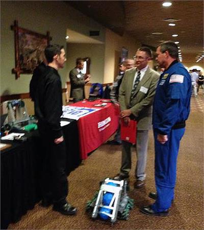 OFHS student Matt Bender talking to Steve Wendel, director of PLTW Ohio, and Astronaut Mike Foreman.